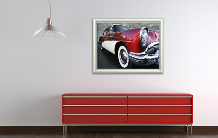 Aluminium Tubular Frame in silver matt color, with poster of old timer car, placed in interíor with red cupboard. Picture frame producer Debex Suisse.