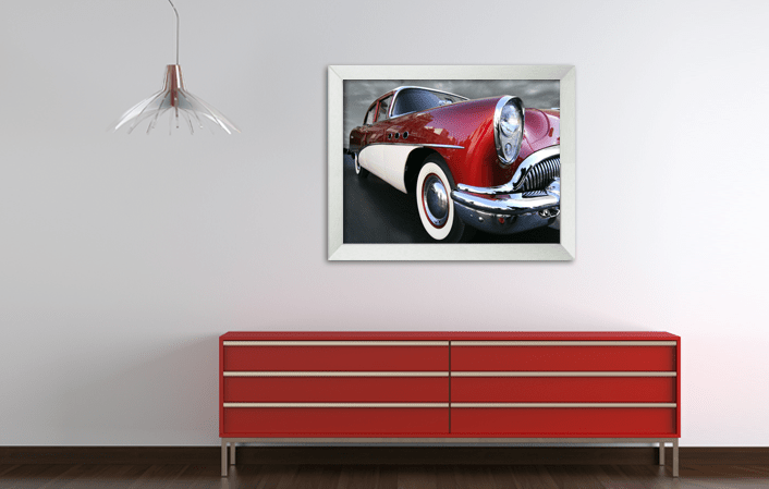 Aluminium Gallery Frame 8980 in silver matt color with picture of an old timer car, placed in interior with red cupboard. Picture frame producer Debex Suisse.