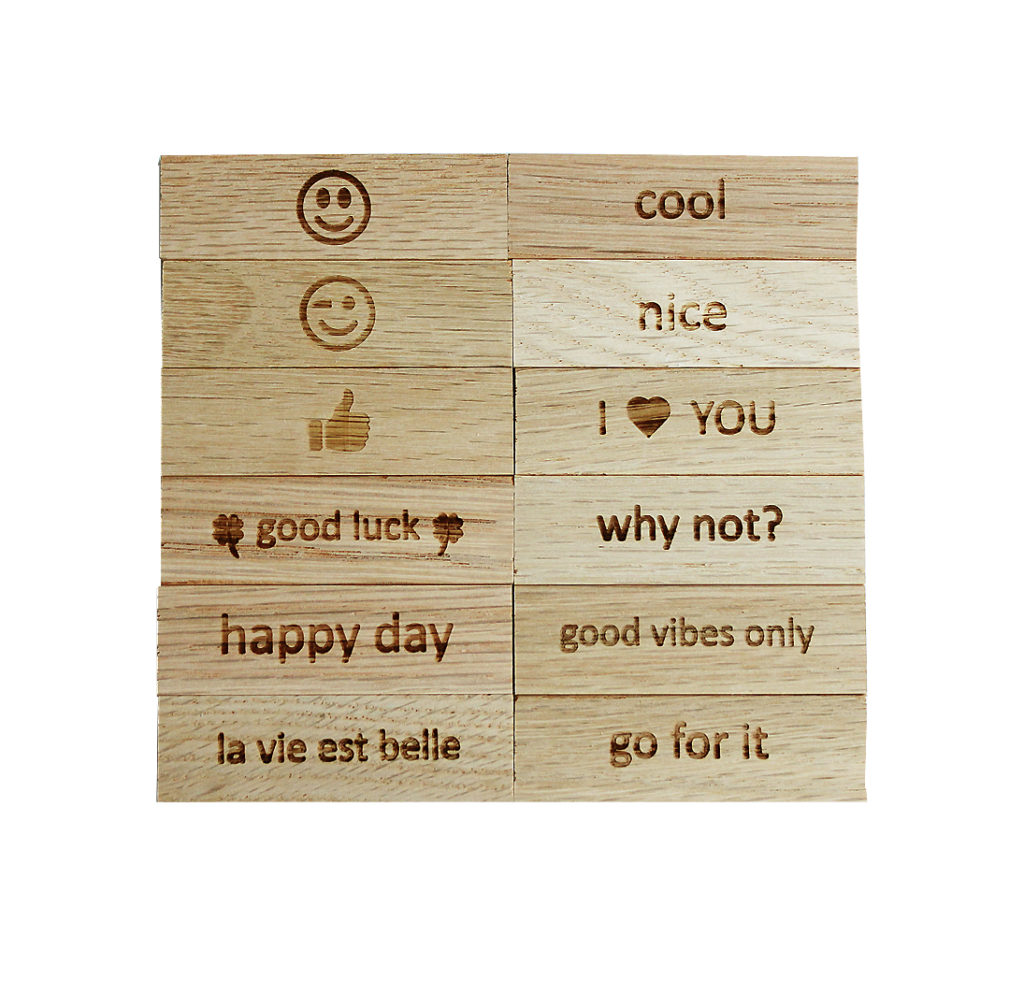 Engraved wooden blocks with positive messages and emojis